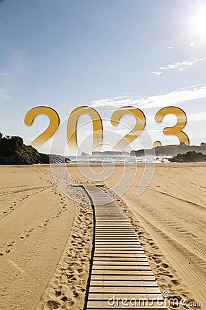 Year 2023 dawning on a light sandy beach. New year concept Stock Photo