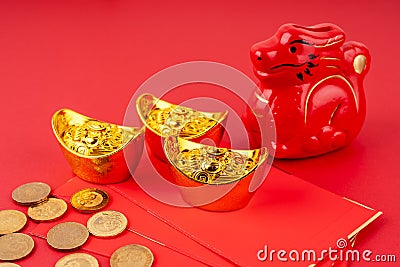 Year of the Dragon with red envelope and gold ingot and coins Stock Photo