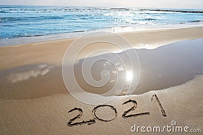 year 2021 numbers spell written on beach Stock Photo