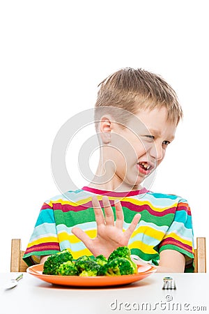 10-year-old boy refuses a plate of broccoli for lunch, concept photo kids Stock Photo