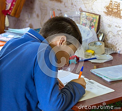 11 year old boy teenager doing school homework Stock Photo