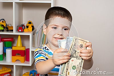 A 4-year-old child learns to count money. Financial literacy and investment education for children Stock Photo