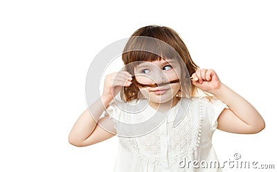4-5 year old girl making a mustache out of hair on white background Stock Photo