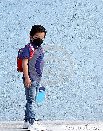 6-year-old Latino boy with covid-19 protective mouthguards, back to school with new normality Stock Photo