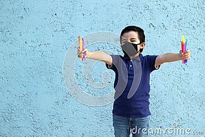 6-year-old Latino boy with covid-19 protective mouthguards, back to school with new normality Stock Photo