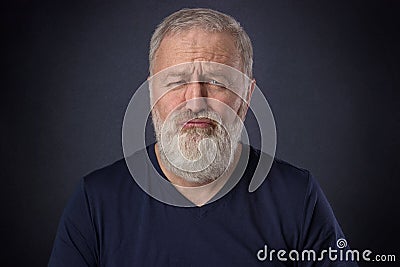 Old man making grimace like a spoiled child Stock Photo