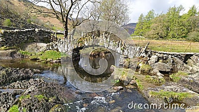 The 300 year old Sadlers Bridge in the Lake District Stock Photo