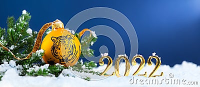 2022 is a year of the Tiger. Happy New Year greeting card. Symbol of year lunar chinese calendar tiger on Christmas ball and gold Stock Photo