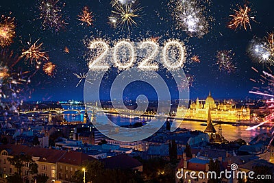 2020 year written with sparkle fireworks on night sky above Budapest Stock Photo