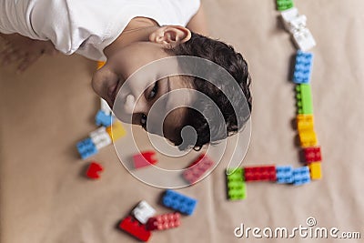 5 years adorable little kid boy playing with plastic brick toys Stock Photo