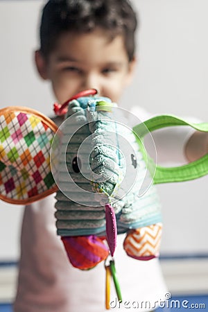 5 years adorable little kid boy playing with plush elephant toy Stock Photo