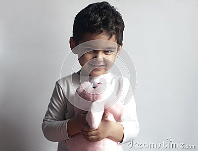 5 years adorable little kid boy playing with plush rabbit bunny toy Stock Photo