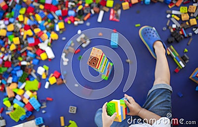 4 years boy building a tower with with interlocking plastic bricks game Stock Photo