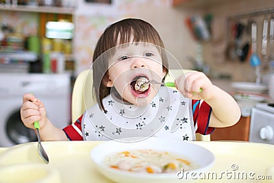 2 years boy eating soup with meat balls Stock Photo