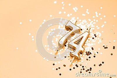 74 years celebration festive background made with golden candles in the form of number Seventy-four Stock Photo