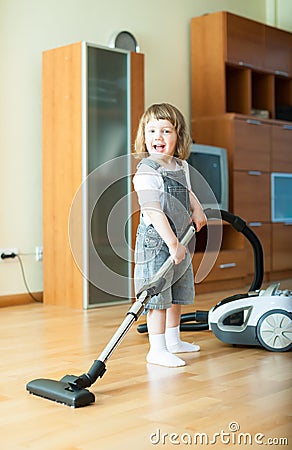 2 years girl with vacuum cleaner Stock Photo