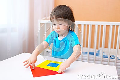 2 years little boy constructing house of paper details Stock Photo