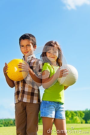 6 years old, boy and girl with balls Stock Photo