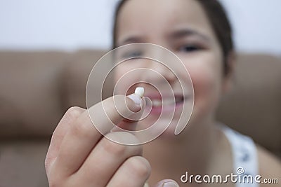 9 years old girl showing her first canine tooth fallen out Stock Photo