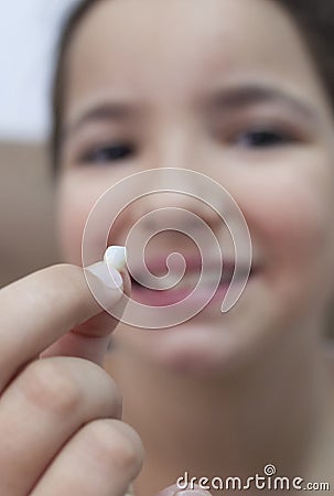 9 years old girl showing her first canine tooth fallen out Stock Photo