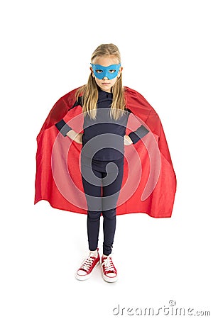 7 or 8 years old young female schoolgirl child in super hero costume performing happy and excited isolated on white background Stock Photo