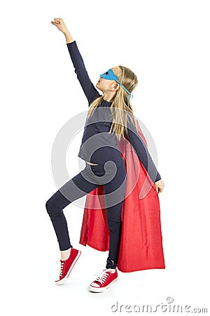 7 or 8 years old young female schoolgirl child in super hero costume performing happy and excited isolated on white background Stock Photo