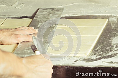 Yeast dough cuted to pieces for making bakes. Stock Photo