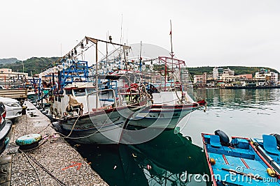 Yehliu fishing harbor with fisherman boats floating on the river in fisherman village in northern Taipei Editorial Stock Photo