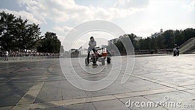 Yekaterinburg, Russia-August, 2019: Quad bike rider performs stunts. Action. Young man freestyle on Quad bike in city Editorial Stock Photo