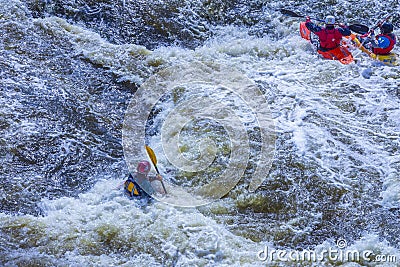 Yekaterinburg, Russia - June 8, 2019: Extreme whitewater rafting trip. A group of people team in kayaks practise traversing the Editorial Stock Photo
