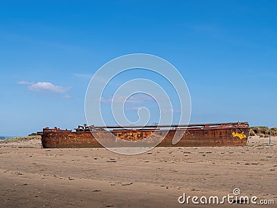 YELLAND, NORTH DEVON, UK - MAY 28 2020: Abandoned broken ship wreck, on sandy shore. Rusting hull on beach. Profile. Editorial Stock Photo