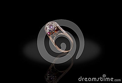 Yello gold precious ball with colored stones ring female with diamonds on black background. Stock Photo