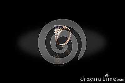 Yello gold precious ring female with diamonds and sapphire on black background. Stock Photo