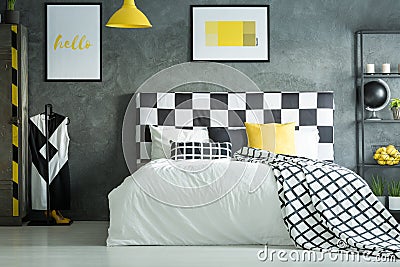 Yellow accent in dark bedroom Stock Photo