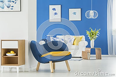 Yellow accents in blue room Stock Photo