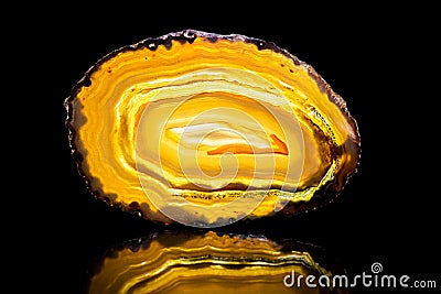 Yellow agate slice, black background, healing stone and mineral Stock Photo