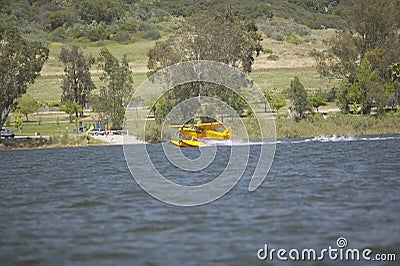 Yellow amphibious seaplane taking off from Lake Casitas, Ojai, California Editorial Stock Photo