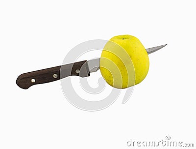 Yellow apple with stabbed knife Stock Photo