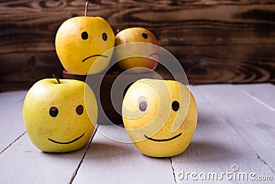 yellow apples with drawn emotions Stock Photo