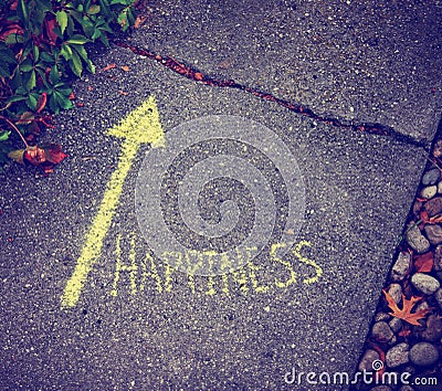 A yellow arrow showing the way to happiness Stock Photo