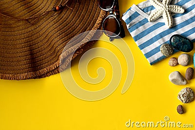 Yellow background with beach accessories, hat, sunglasses, shirt Stock Photo