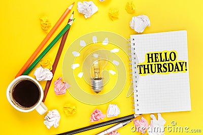 On a yellow background, a cup of coffee, a light bulb, pencils, a notebook with the inscription - HELLO THURSDAY Stock Photo