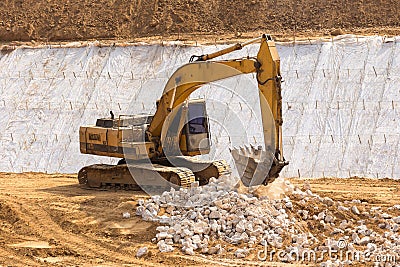 yellow backhoe work in the dam Stock Photo