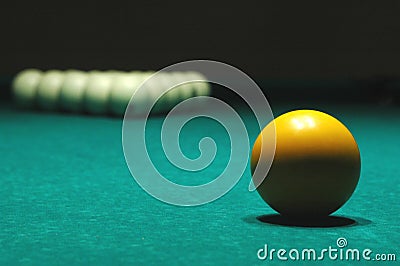 Yellow ball on billiard table Stock Photo