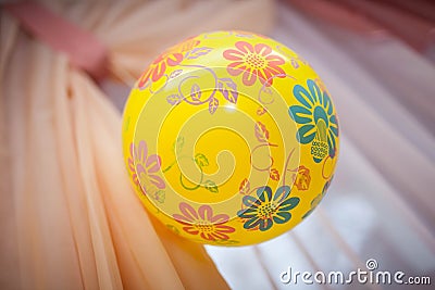 Yellow ball with patterns weighs Stock Photo