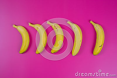 Yellow bananas on fuchsia background Stock Photo