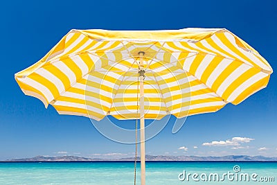 Yellow beach umbrella Stock Photo