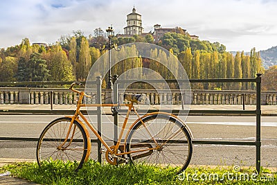 Yellow bicycle along the river in Turin Piedmont, Italy Editorial Stock Photo