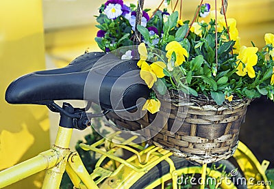 Yellow bicycle decorated with flowers Stock Photo