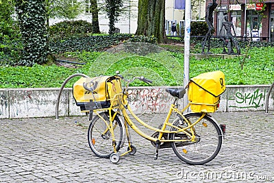 Yellow bicycle of postman from Deutche post, Berllin Editorial Stock Photo